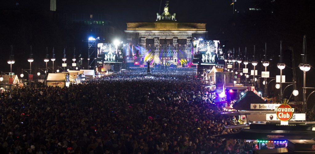 Revelers crowd the avenue in front of Berlin's Brandenburg gate (background) on December 31, 2012, as they wait to usher in the New Year. AFP PHOTO / JOHN MACDOUGALL (Photo credit should read JOHN MACDOUGALL/AFP/Getty Images)